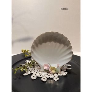 White ceramic 4" shell shaped bowl with ceramic dainty flowers attached.
